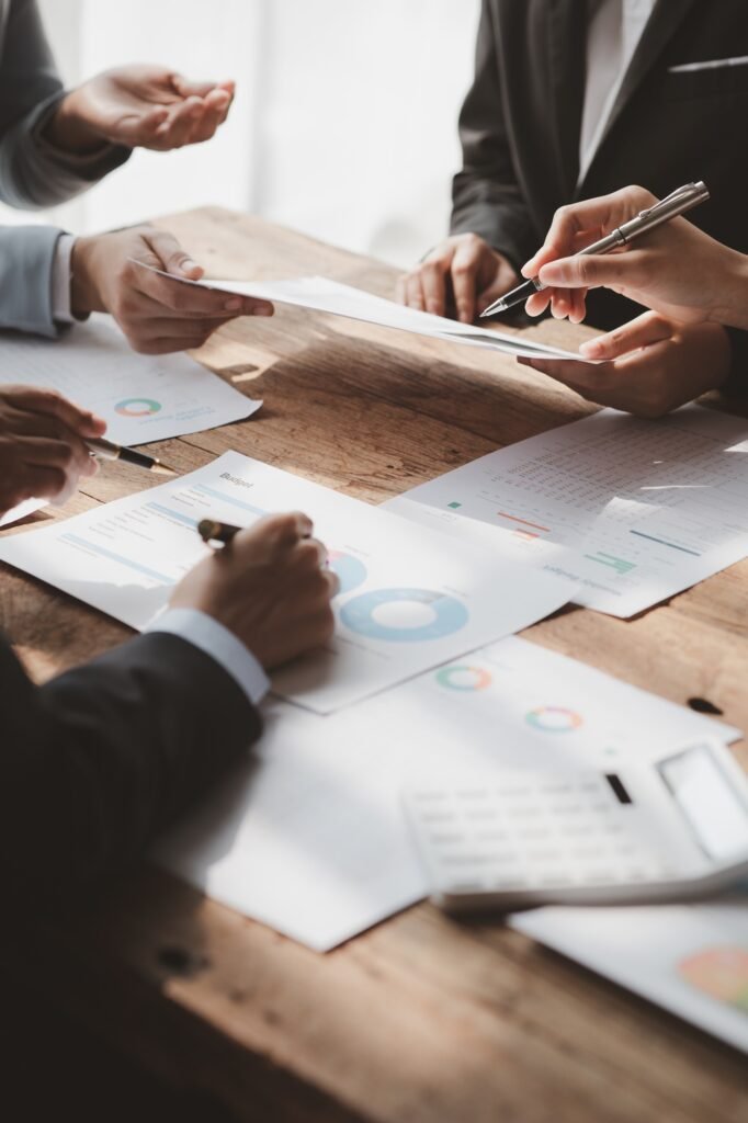 Businessman is reviewing monthly sales documents for analysis and marketing plans for more sales gro